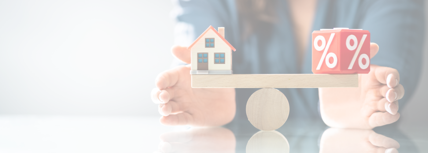 A scale balancing a home and a percentage rate as a metaphor.