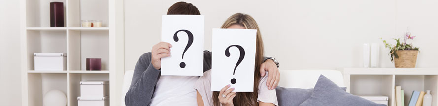 image of a couple holding up a sign with question marks